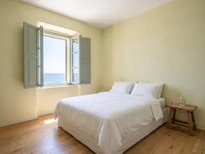 Example apartment: bedroom with white linen