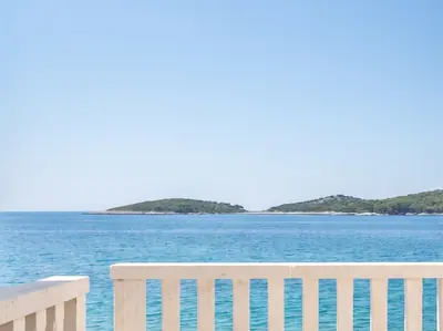 Example apartment: terrace railing with the sea and islands beyond