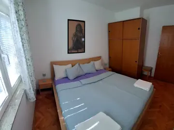 Apartment photo: bedroom with a double bed and a wardrobe