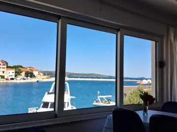Apartment photo: harbour and boats seen through a large window