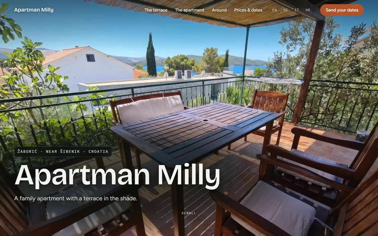 Apartman Milly home page: terrace with a wooden table and chairs under a pergola